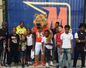 Local youth are treated to a Morgan State Bears football for their participation in the bike riding program