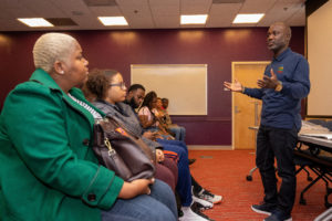 Omar Muhammad speaking in a classroom