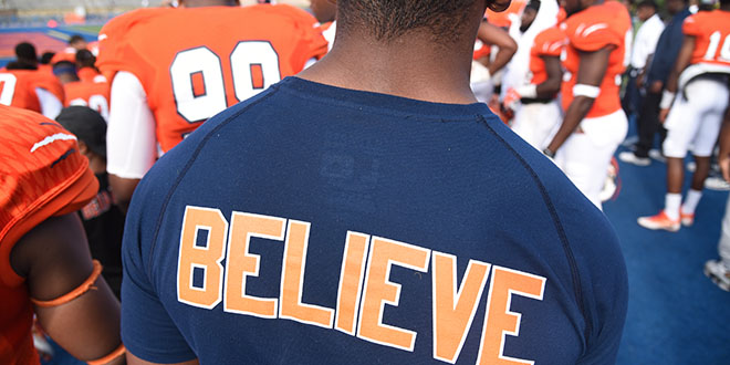photo of student wearing a t-shirt that says believe